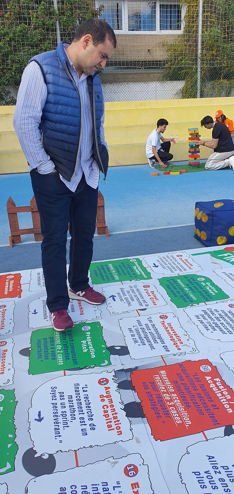 Participant sur un jeu de plateau géant au sol